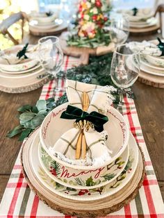 the table is set for christmas dinner with plates and napkins