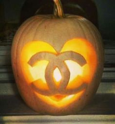 a pumpkin carved to look like the chanel logo