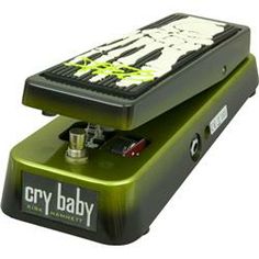 the grey baby guitar pedal is green and black