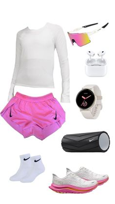 a woman's white top, pink shorts and nike shoes are arranged in the shape of a heart