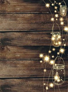 mason jars and lights are hanging on a wooden wall with string lights in the shape of stars