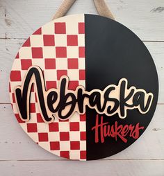 a sign hanging on the side of a building that says nebaska huskers