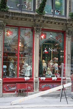 a store front with christmas decorations on the windows