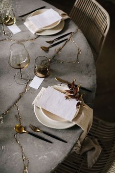 the table is set with silverware and place settings