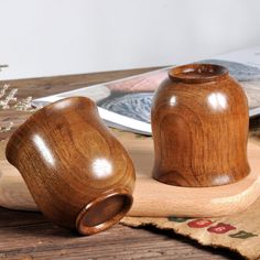 two wooden salt and pepper shakers on a table