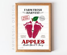 a wooden frame hanging on the wall displaying an advertisement for apples