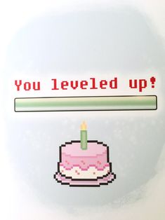 a birthday cake with a lit candle on it and the words you leveled up