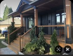 the front porch of a house with trees and bushes