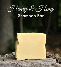 honey and hemp shampoo bar sitting on top of a tree stump