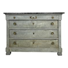 an old chest of drawers with gold handles and knobs on the front, against a white background