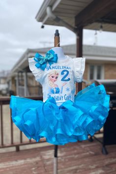 a blue and white birthday outfit on a pole