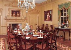 a formal dining room with fancy chandelier and table set for six people,