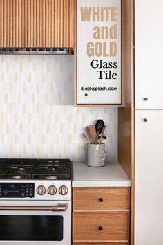 a white and gold glass tile backsplash in a kitchen with an oven, stove and cabinets