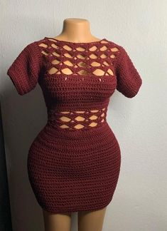 a crocheted dress is displayed on a mannequin