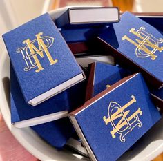 several blue and gold books on a white plate