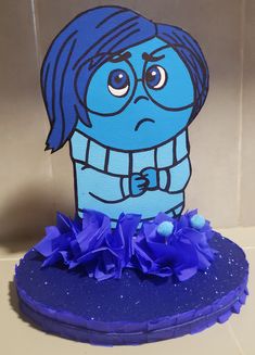 a blue cake with a cartoon character on it