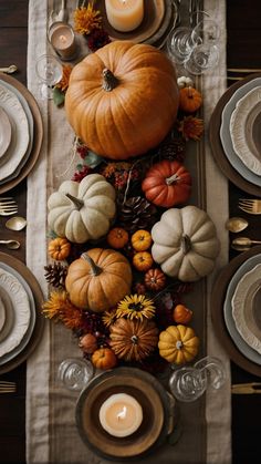 a table topped with lots of different types of pumpkins and other autumn decor items