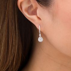 Elevate your dressy looks with these elegant multi-diamond teardrop hoop earrings. Created in 14K white gold Each drop showcases a teardrop-shaped composite of diamonds wrapped in a diamond-lined frame. A shimmering diamond connects the dangle to the diamond-adorned hoop. These 1 cts. t.w. diamond earrings secure with hinged backs. Teardrop Diamond Earrings, White Diamond Accented Pear-shaped Teardrop Earrings, White Diamond-accented Teardrop Earrings, White Pear-shaped Teardrop Earrings With Diamond Accents, Pear-shaped Diamond Earrings In Fine Jewelry Style, White Diamond-cut Teardrop Earrings, White Diamond Cut Teardrop Earrings, Teardrop Diamond Cut Diamond Earrings, Teardrop Diamond Cut Earrings