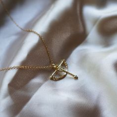 Artemis Necklace Bow and Arrow Necklace Gold Charm Necklace Huntress Necklace Gift for Her Minimalist Jewelry Mythology Inspired Minimalist __LISTING DESCRIPTION ☽ 18k Gold Plated Charm (21.2x19.7x3mm), Cubic Zirconia, !!the bow and arrow are two separate charms attached together, the arrow can move around ☽ This charm is gold plated meaning that it will tarnish over time. PLEASE follow these tips to make the charm last longer in its original condition: avoid wearing it to the beach, pool, showe Bow And Arrow Jewelry, Bow And Arrow Necklace, Artemis Necklace, Greek Mythology Jewelry, Bow And Arrow, Small Jewelry Box, Gold Charm Necklace, Fantasy Jewelry, Small Jewelry