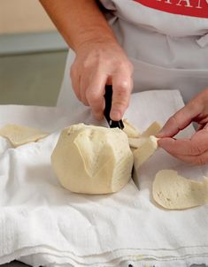 a person is preparing food on a white towel