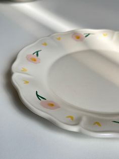 a white plate with flowers painted on it