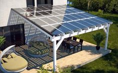 an aerial view of a house with a solar panel on the roof and patio furniture