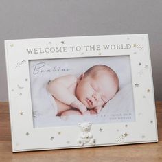 a baby's photo frame with the words welcome to the world and a teddy bear