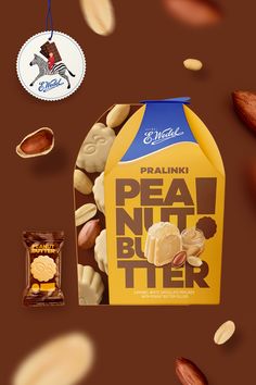 peanuts, peanut butter and almonds are scattered around the packaging on a brown background