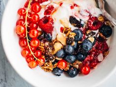 a bowl filled with yogurt, berries and granola