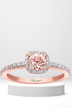 a pink diamond engagement ring on top of a white stand with diamonds around it and the words, bridal