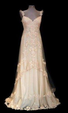 a white wedding dress on display in a black background with the back of it's gown