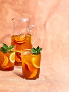 three glasses filled with iced tea and orange slices