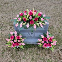 flowers are placed on the headstone of a grave in the middle of a field