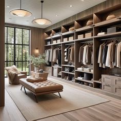 a large walk in closet with lots of clothes