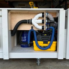 a yellow and blue blow dryer sitting inside of a cabinet