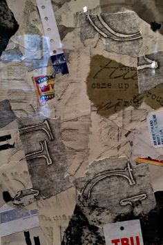 a piece of torn paper with writing on it and some stickers attached to it