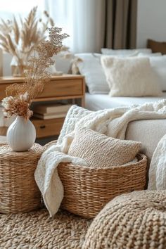 a living room with wicker baskets and pillows on the floor, next to a bed