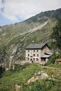 an old stone building on the side of a mountain