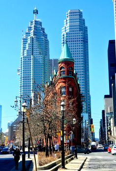 a city street with tall buildings in the background