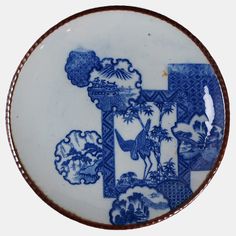 a blue and white plate with designs on it