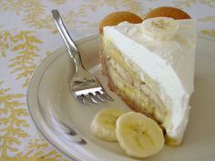 a piece of cake on a plate with banana slices and a fork next to it