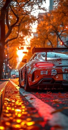 a sports car is parked on the side of the road in the city at sunset