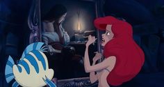 ariel from the little mermaid looking at herself in her mirror while another fish looks on