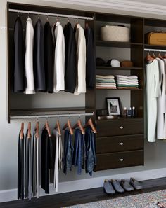 an organized closet with clothes and shoes