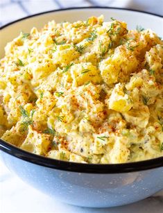 a bowl filled with potato salad on top of a table