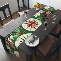 the table is set for christmas dinner with silverware, fruit and wine glasses on it