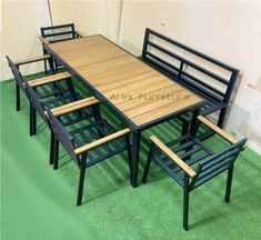 an image of a table and chairs set up on the green carpeted flooring