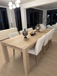 a large wooden table with white chairs around it