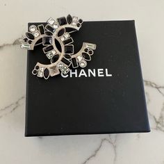 Pre Owned Blk And White Chanel Broach. Super Classy And Iconic. Missing 1 Stone Please See Pictures. Chic Black Brooches For Gifts, Chanel Costume Jewelry Vintage Fake, Luxury Black Statement Brooch, Chanel Camellia Brooch, Chanel Brooch Farfetch, Chanel Brooch, Chanel Accessories, See Picture, Chanel