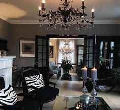 a living room filled with furniture and a chandelier